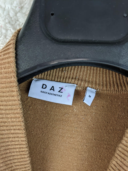 Close-up of DAZ sweater label showing size M