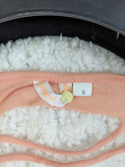 Rip Curl size tag on peach tank top