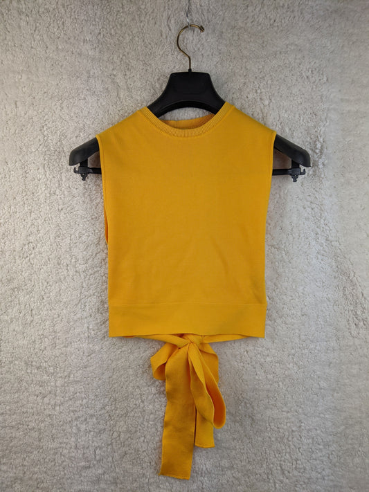 Yellow sleeveless top with tie-back on hanger - front view