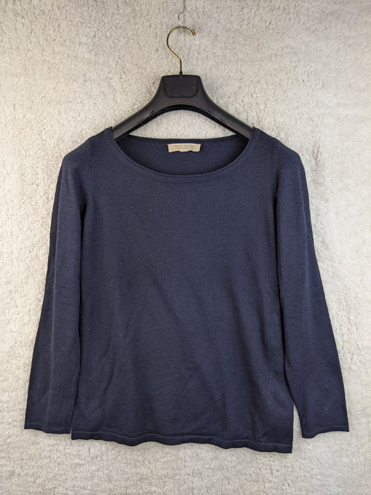 Front view of a navy blue long sleeve top on a hanger