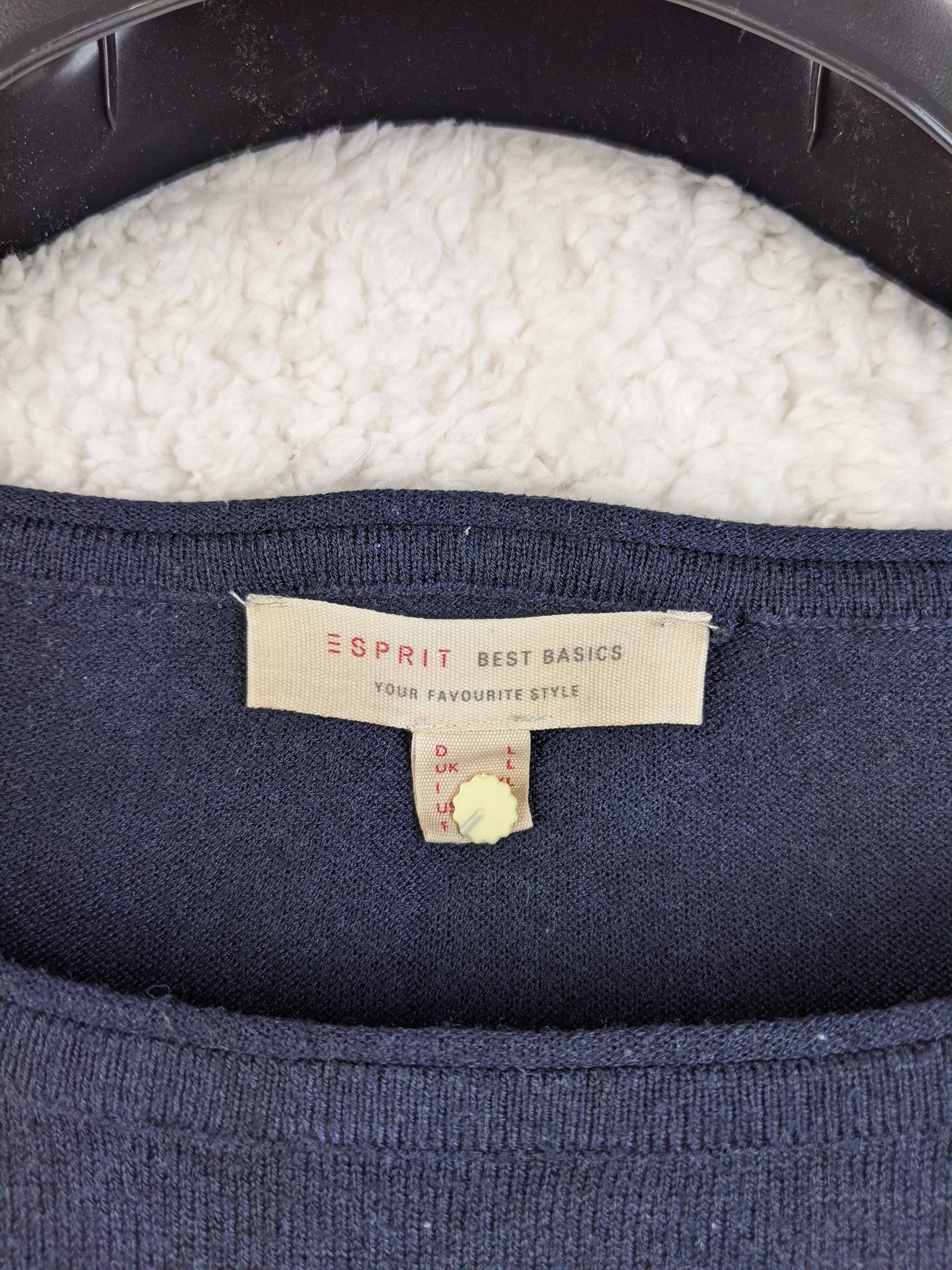 Close-up of the Esprit tag on the navy blue top