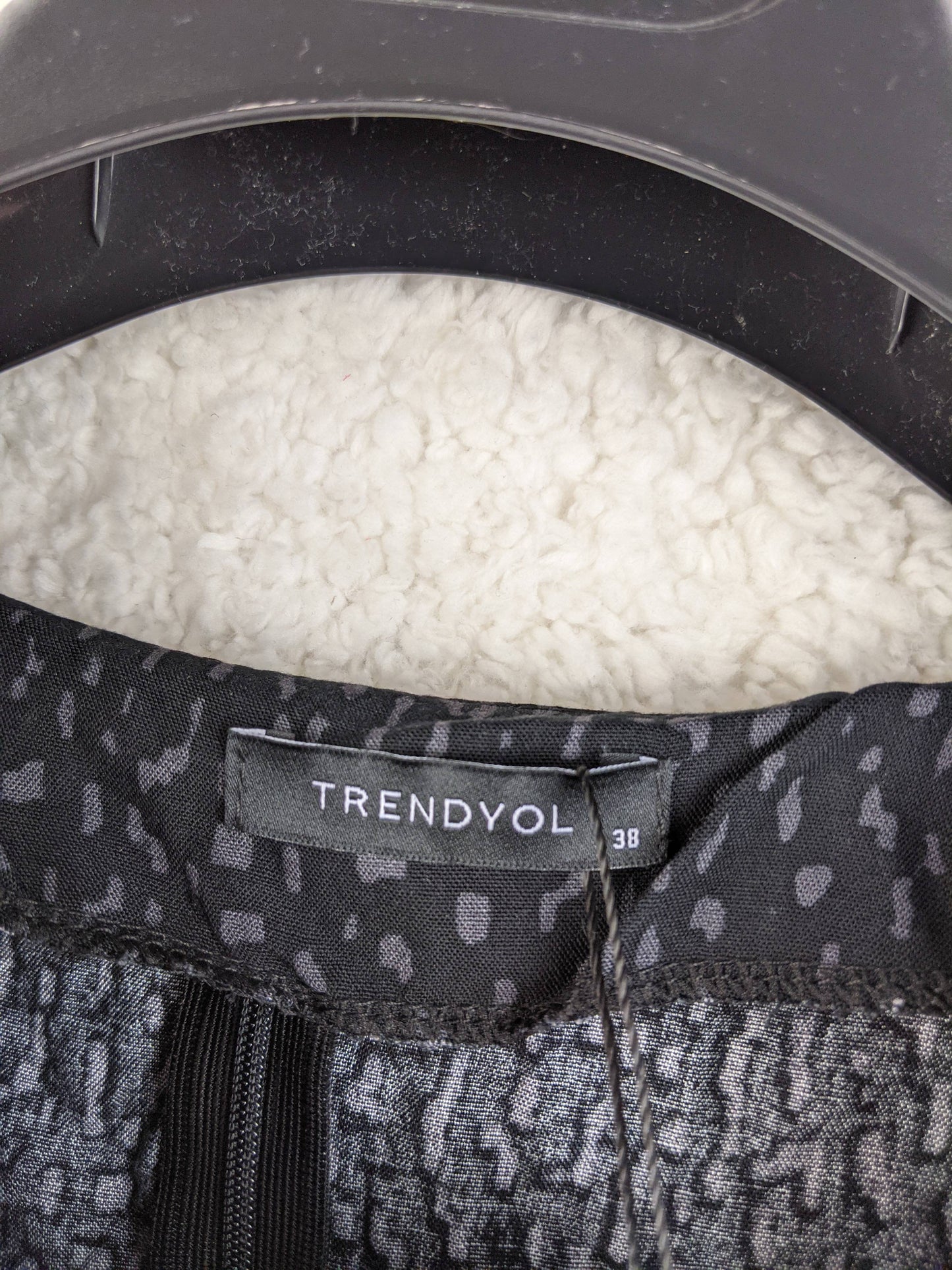 Close-up of label on Trendyol black dotted blouse