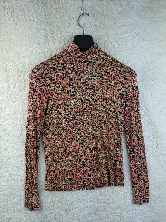 Floral print long sleeve top hanging on a hanger
