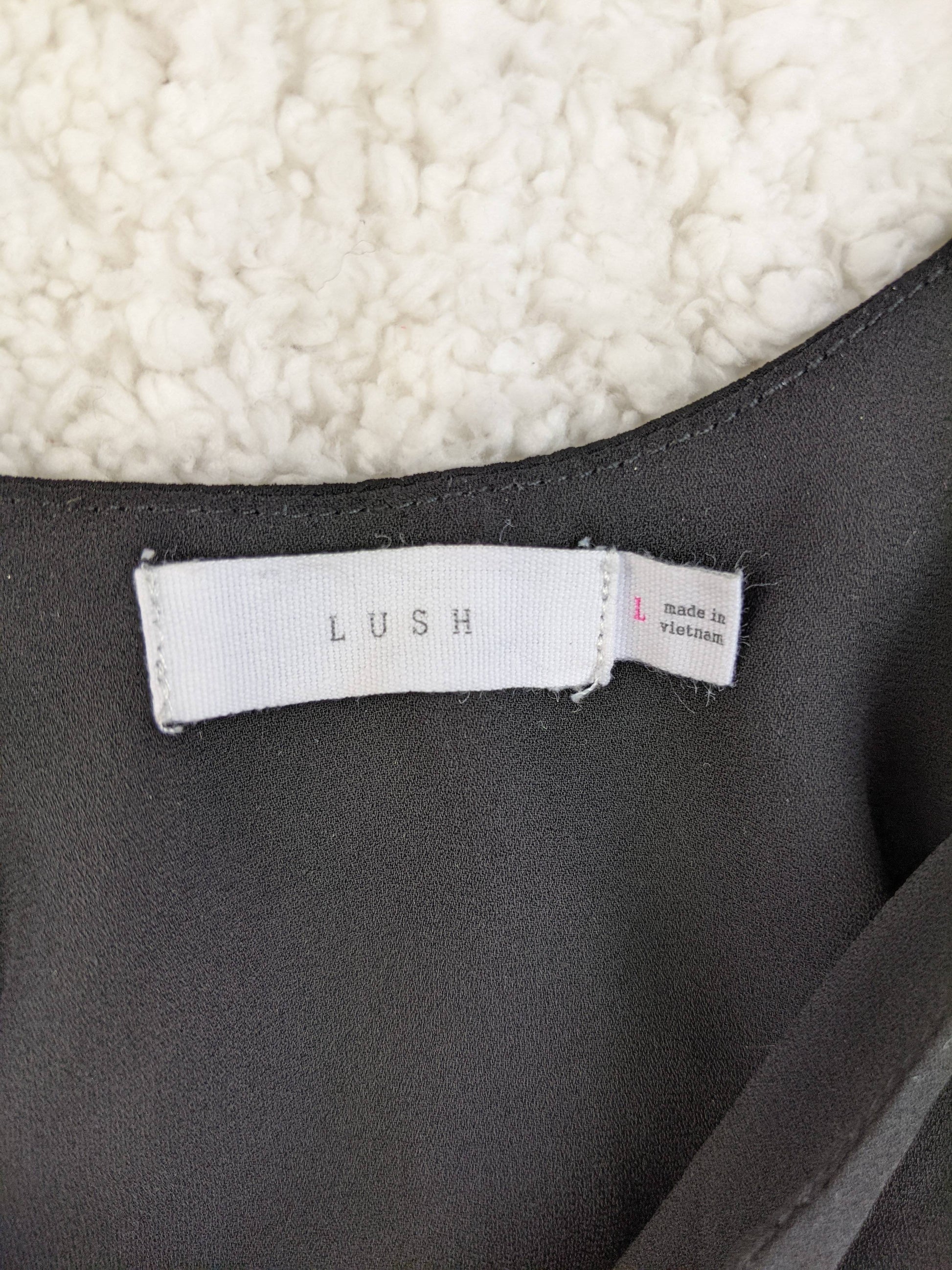 Label of Lush black cami top