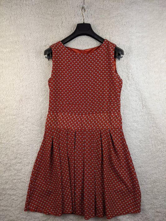 Front view of red patterned dress on hanger