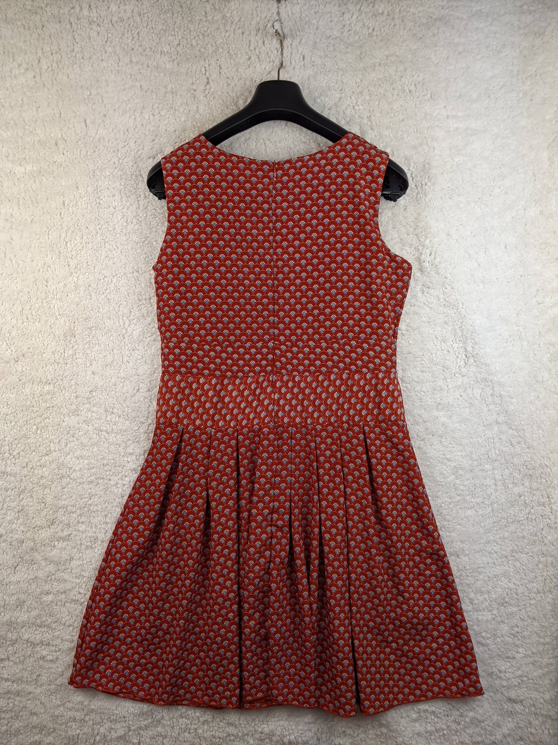 Back view of red patterned dress on hanger