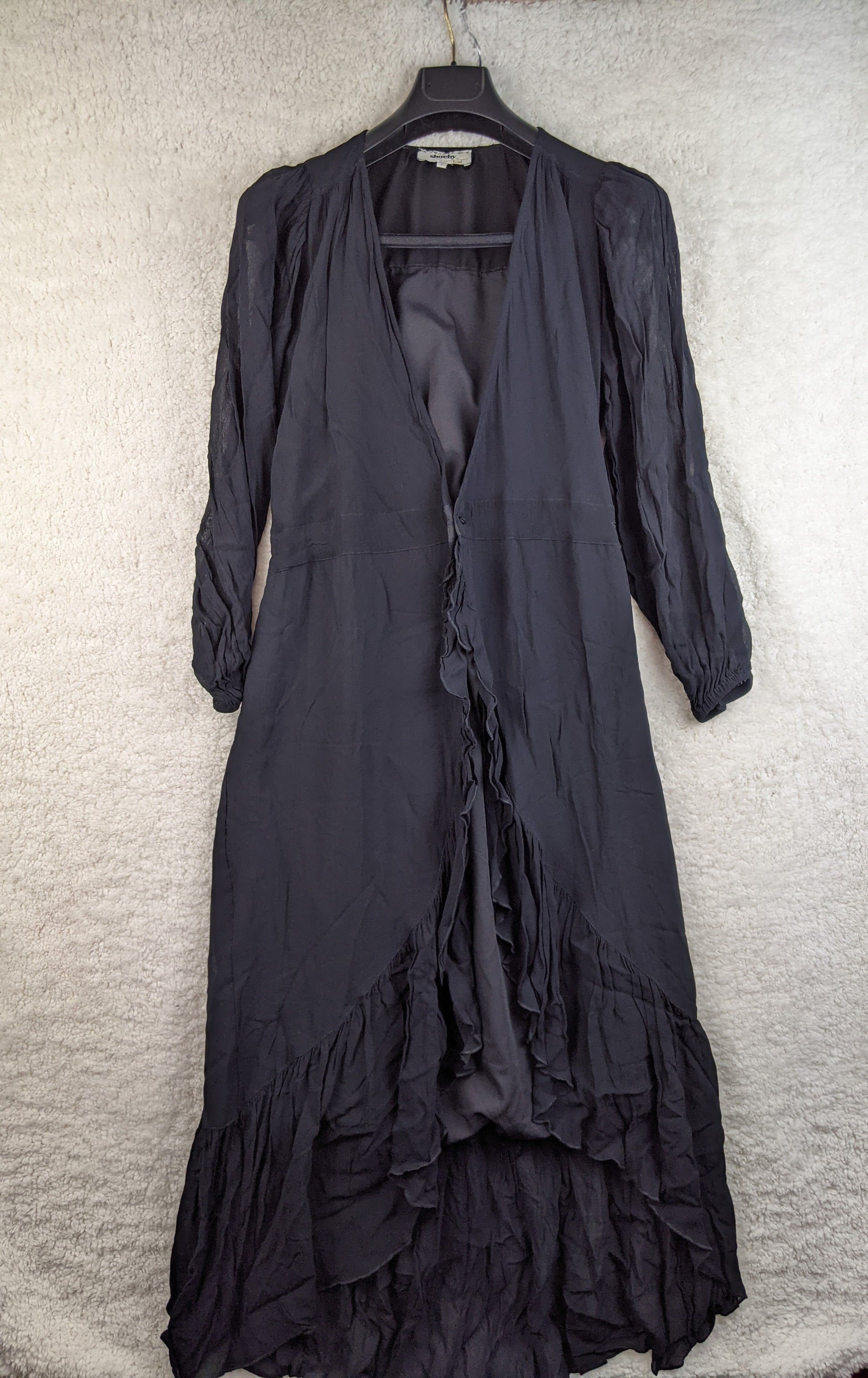 Front view of black ruffled long dress