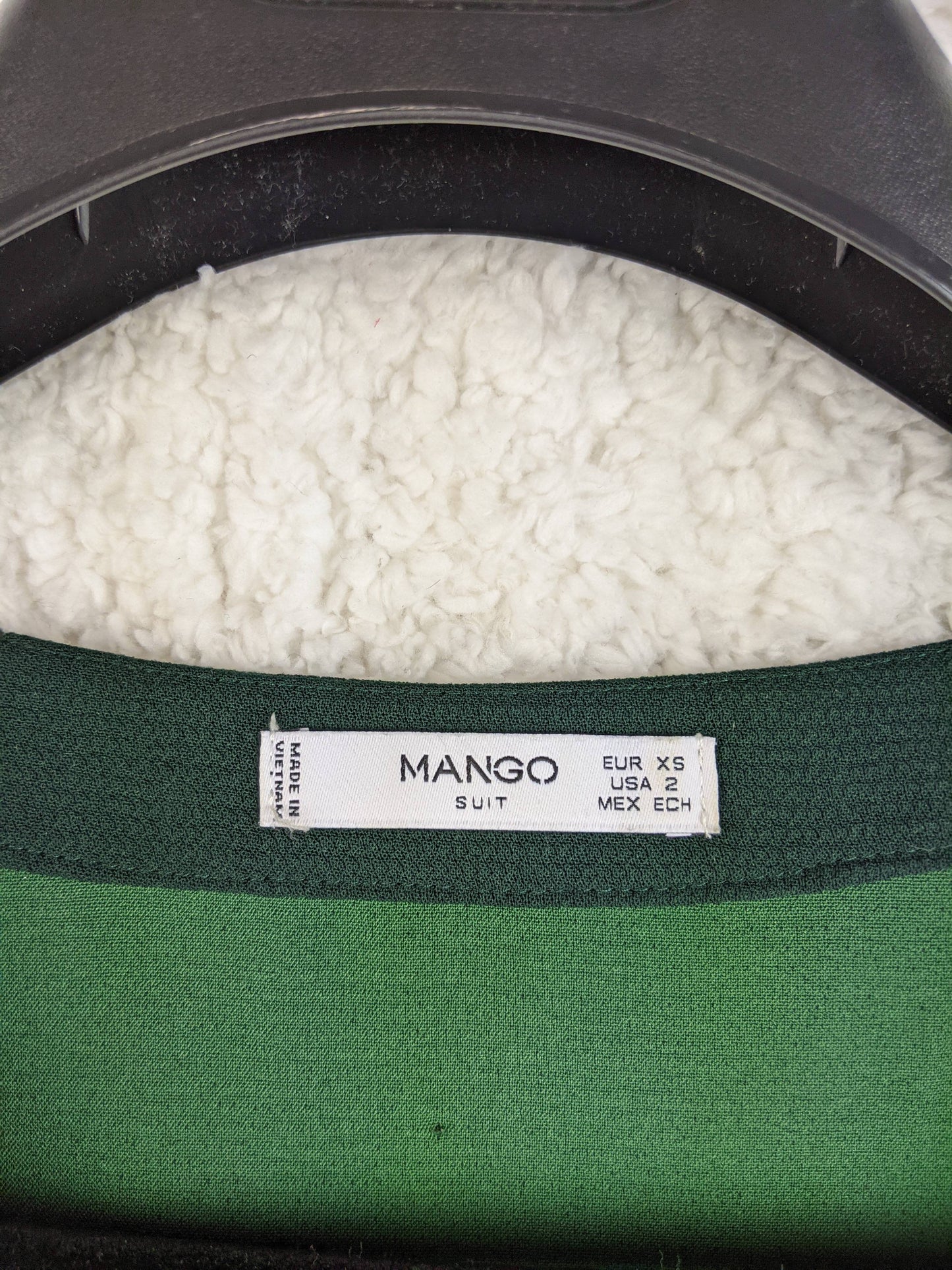Close-up of Mango dress label showing size XS