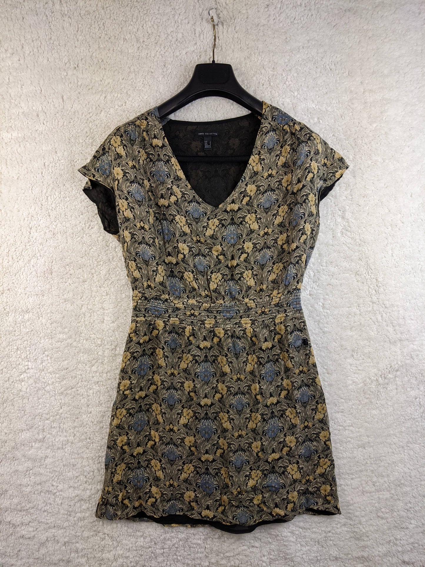Front view of the vintage-style dress on a hanger