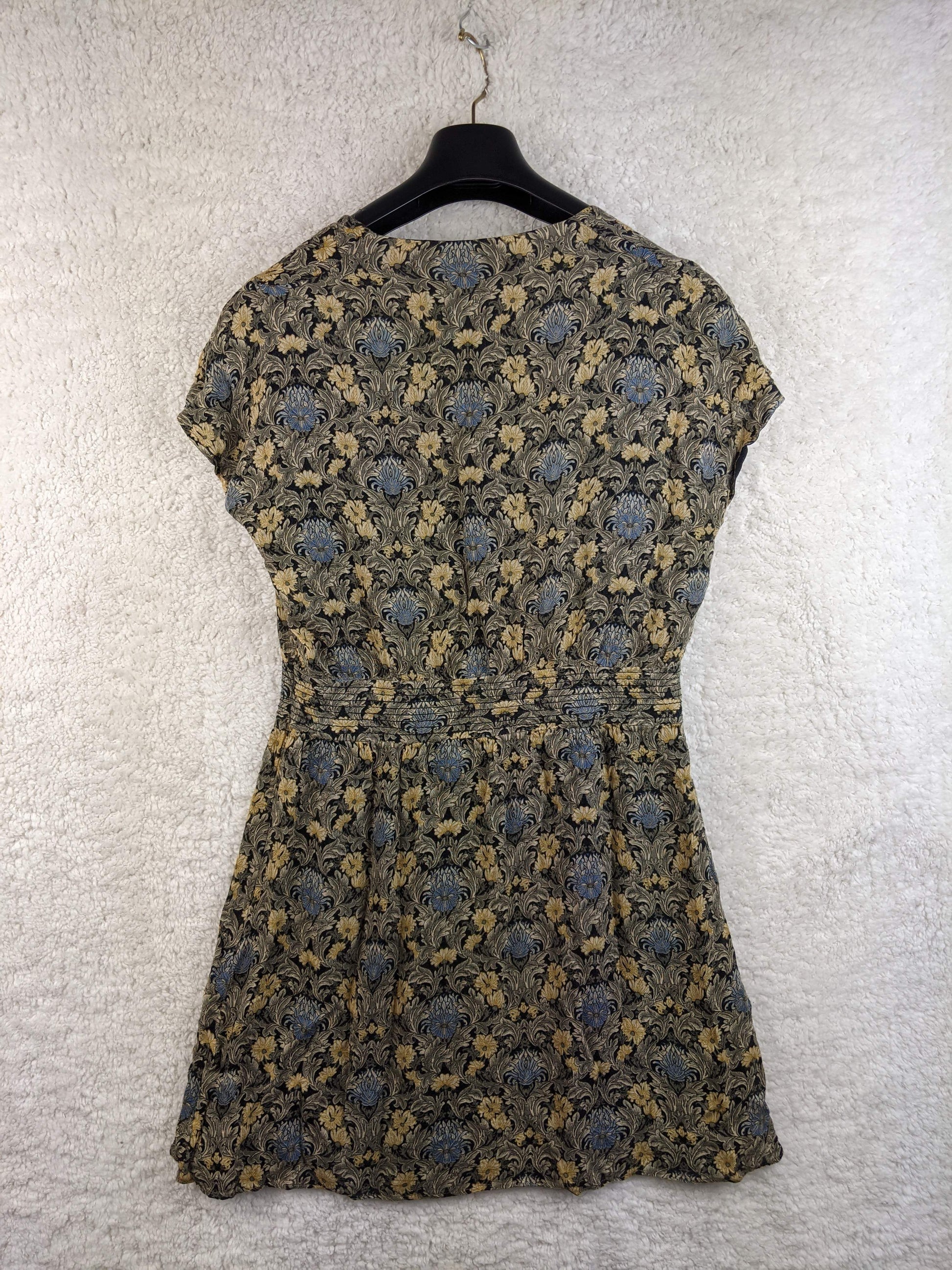 Back view of the vintage-style dress on a hanger