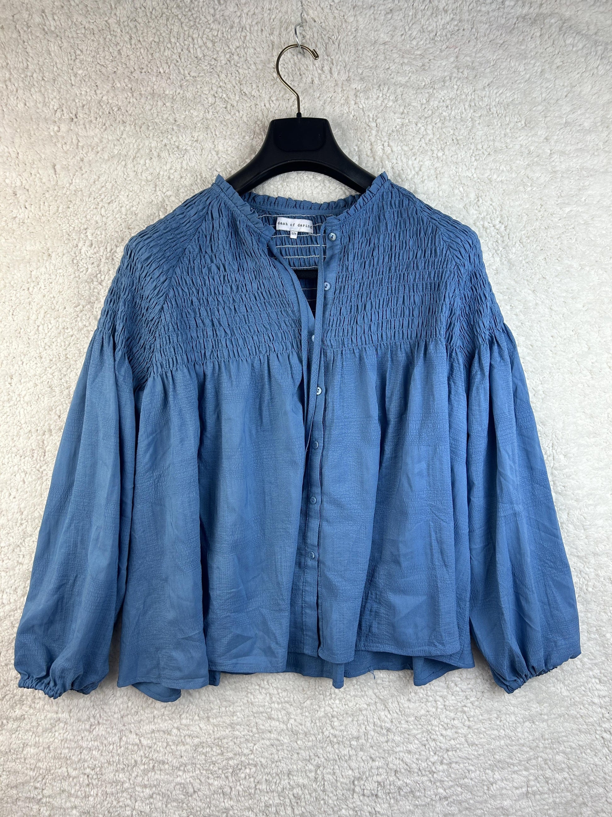 Front view of Dash of Daring blue smocked blouse