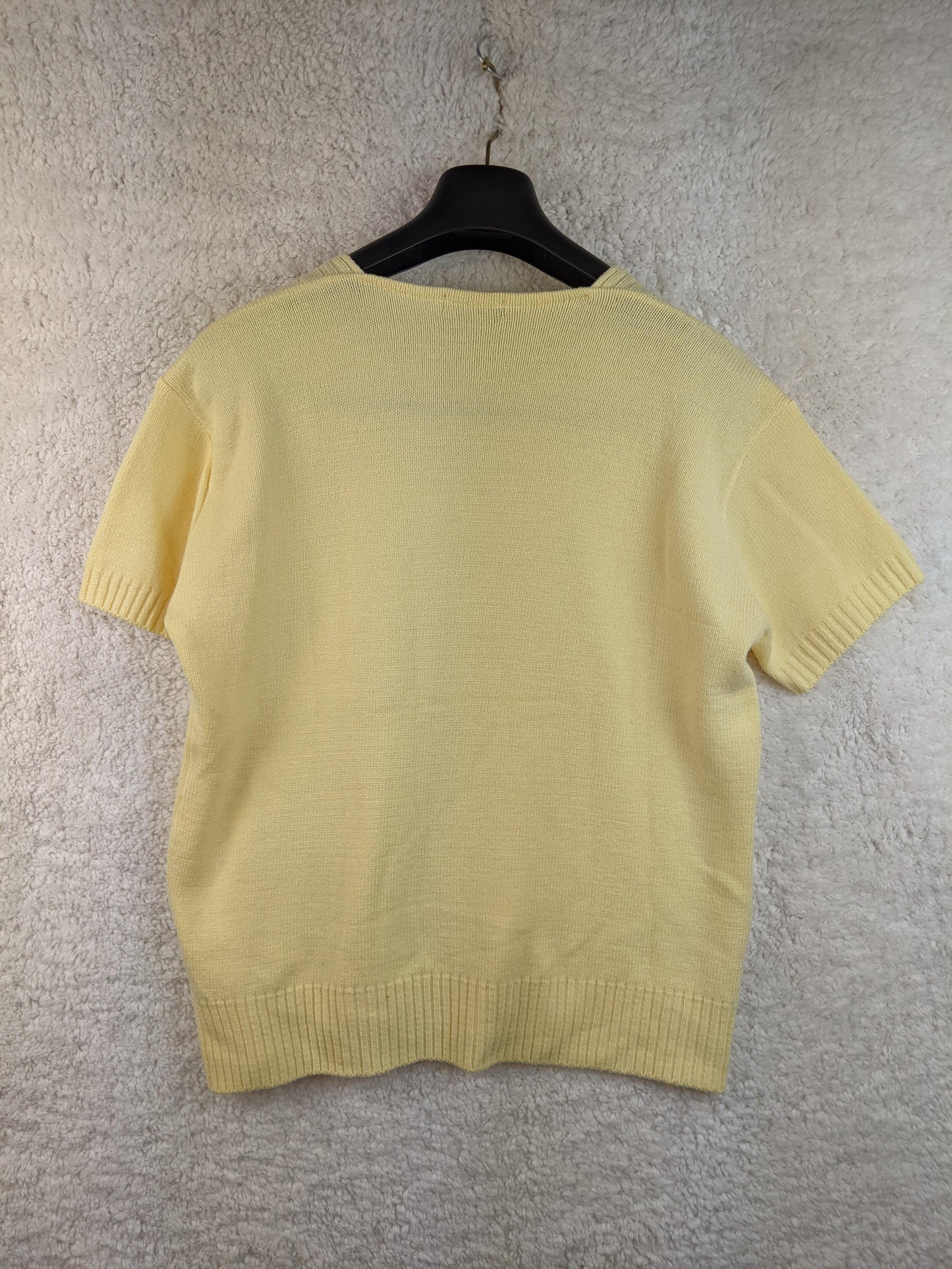 Back view of yellow cable knit sweater