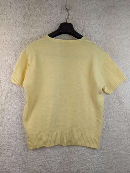 Back view of yellow cable knit sweater
