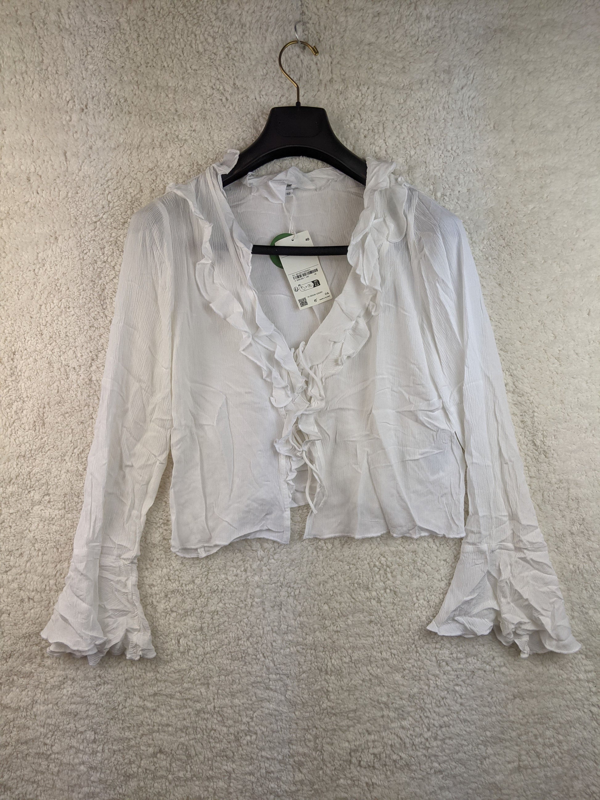 Front view of white ruffled blouse