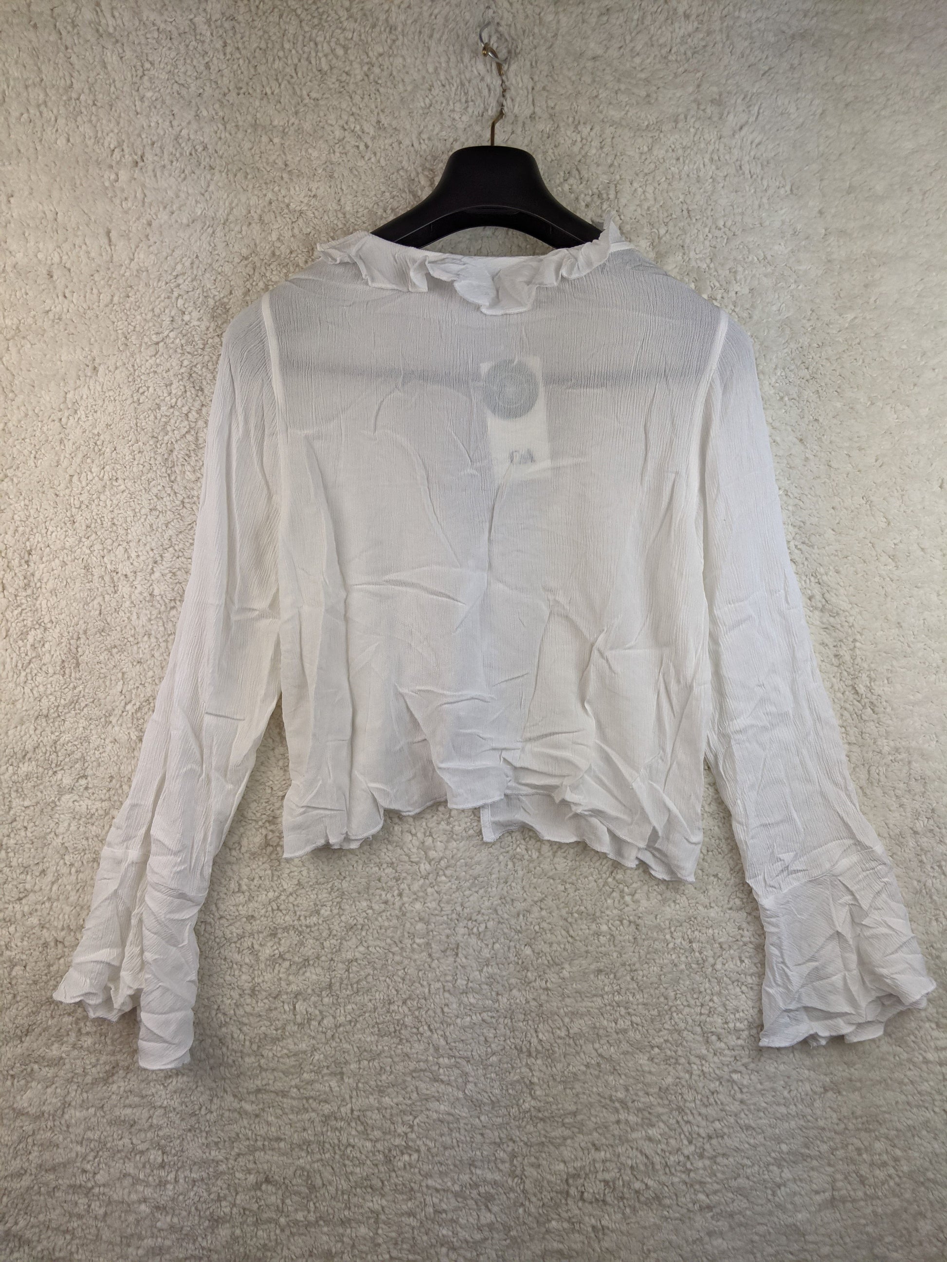 Back view of white ruffled blouse