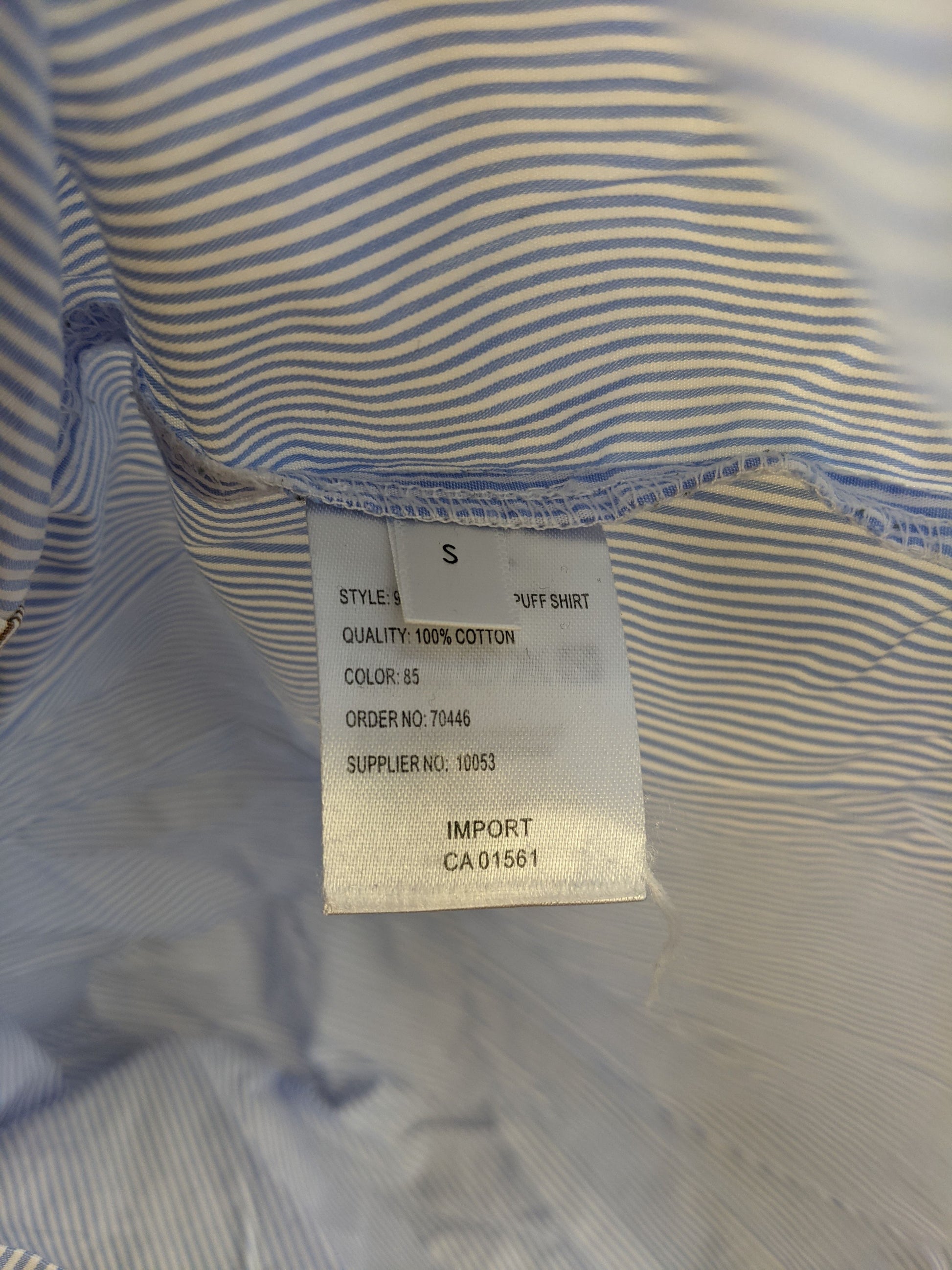 Material tag of Co'couture shirt indicating 100% cotton