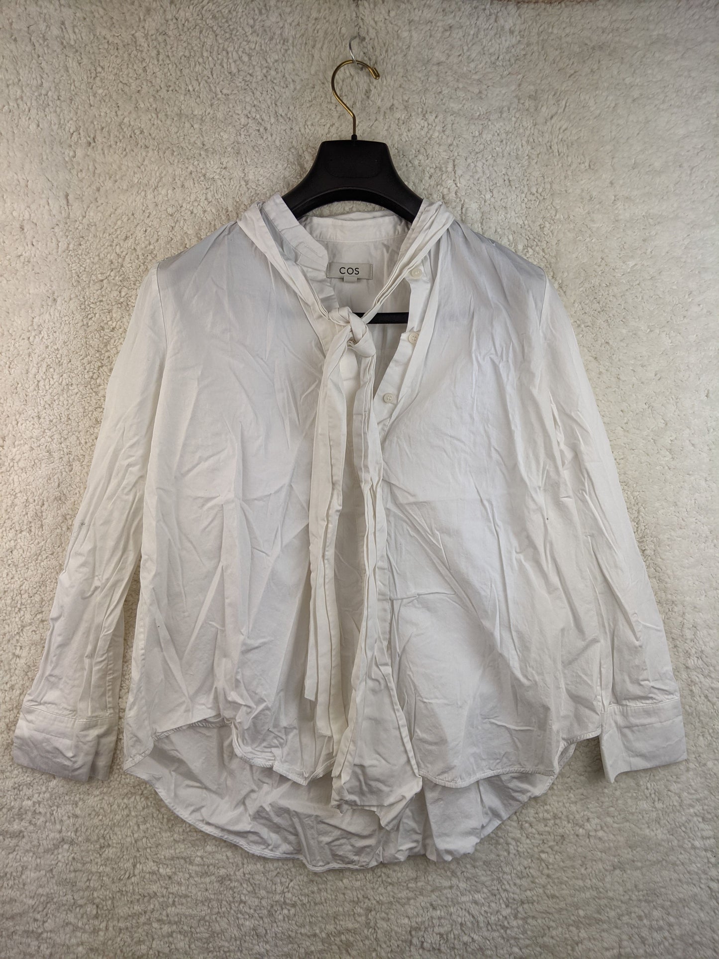 Front view of COS white tie-neck blouse