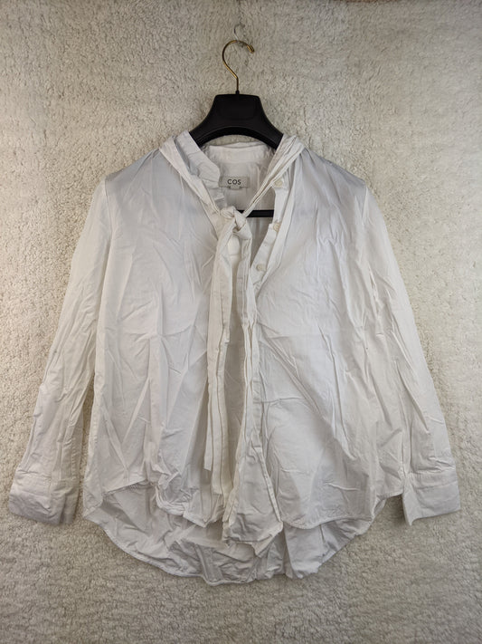 Front view of COS white tie-neck blouse
