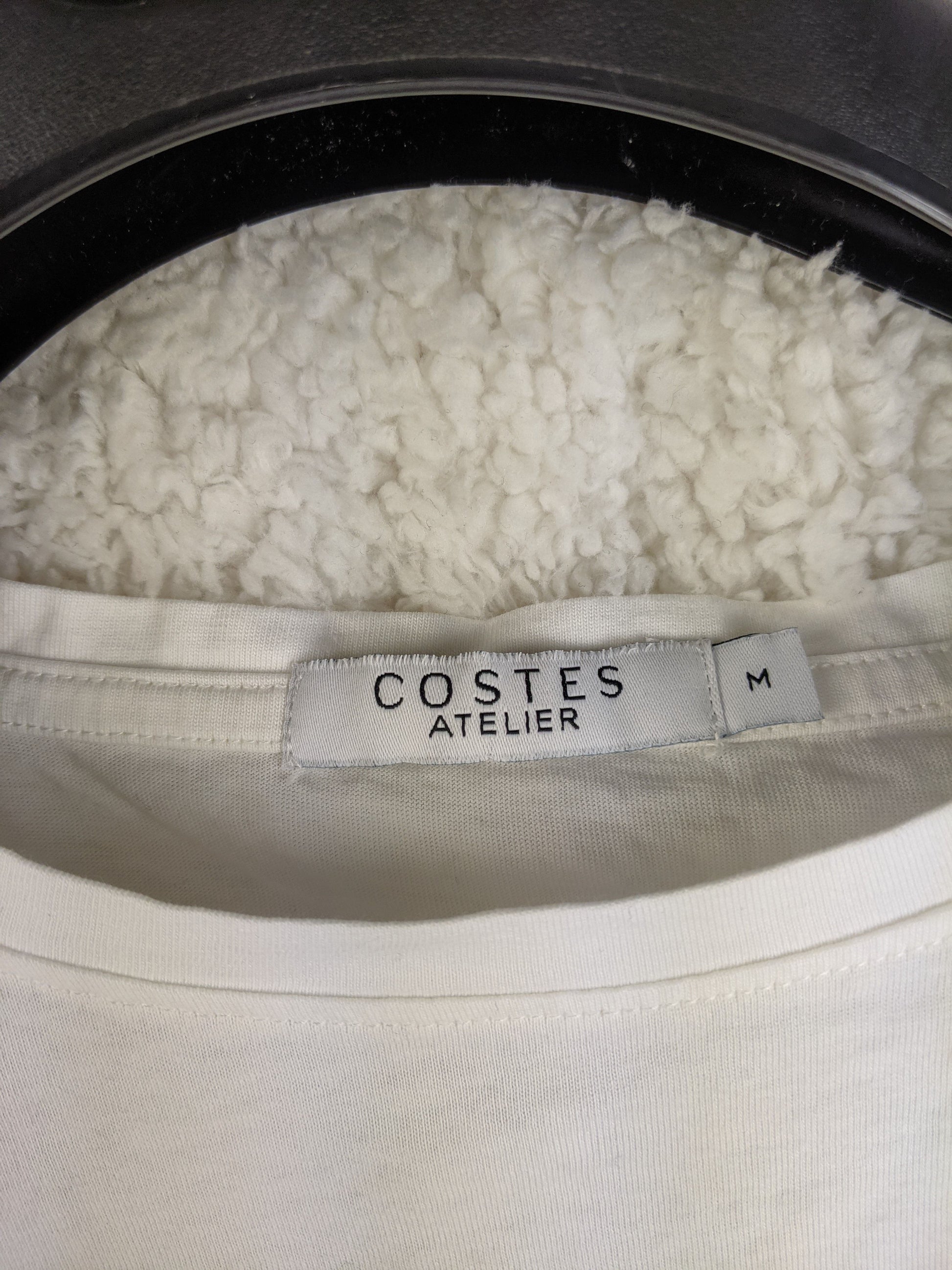 Close-up of Costes Atelier label showing size M