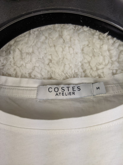 Close-up of Costes Atelier label showing size M