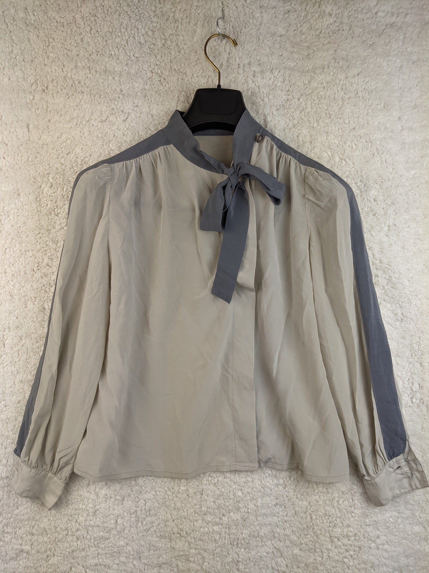 Front view of grey blouse with bow tie detail