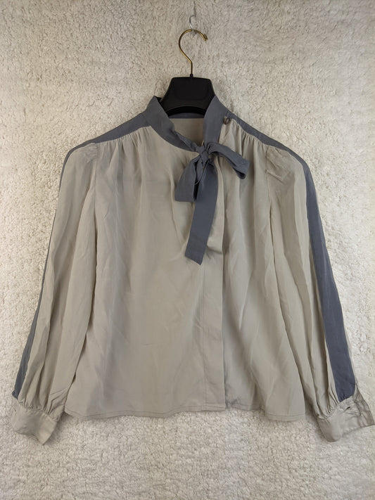 Front view of grey blouse with bow tie detail