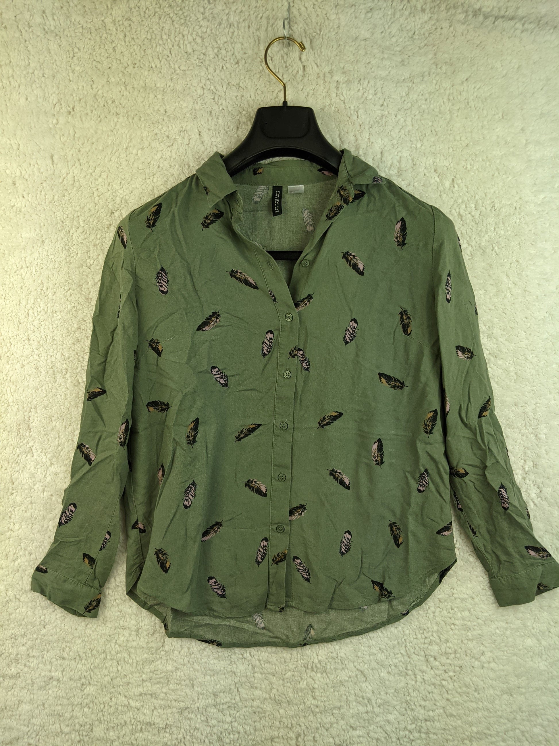 Front view of green feather print shirt