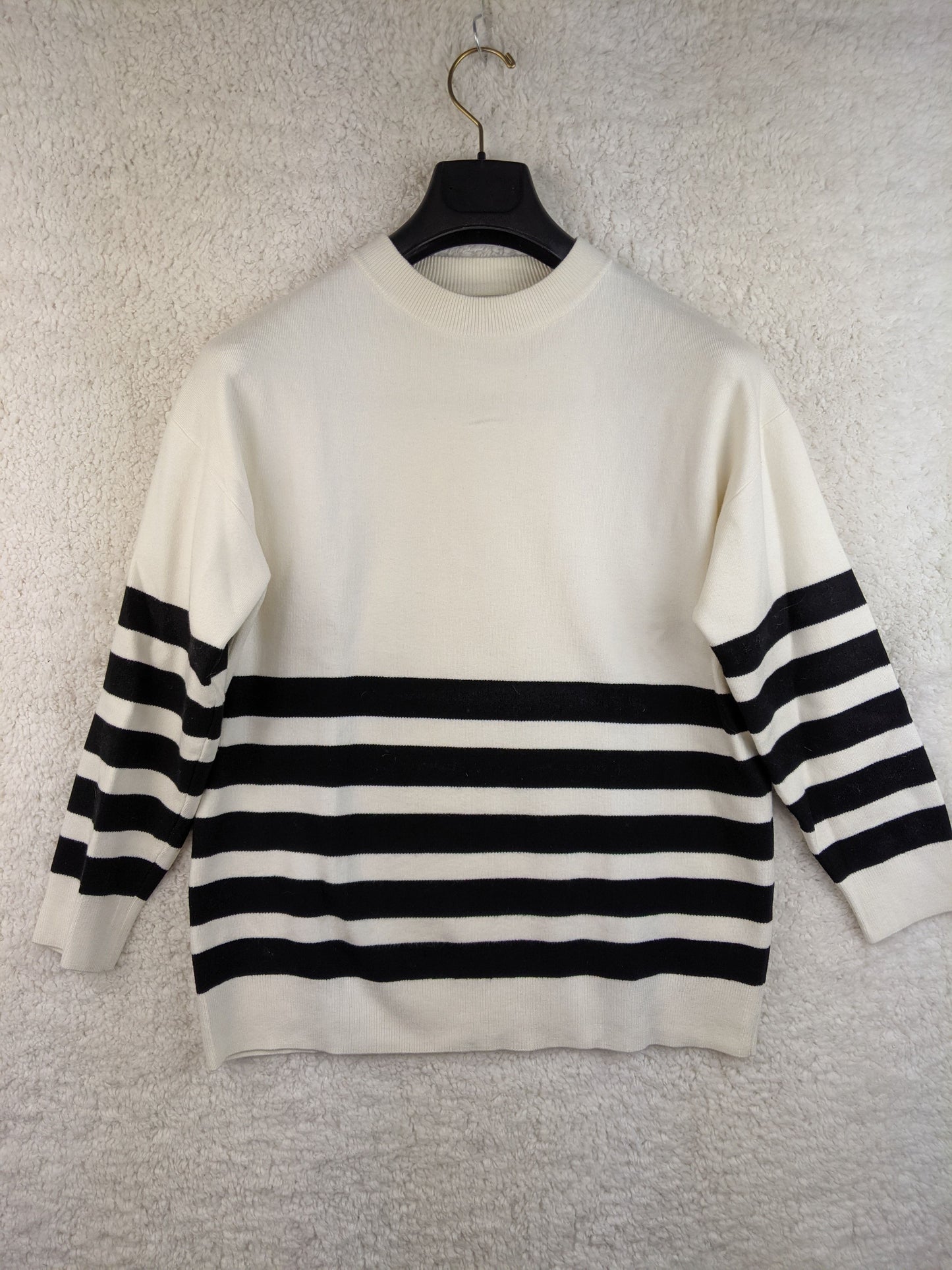 Front view of MNG black and white striped sweater