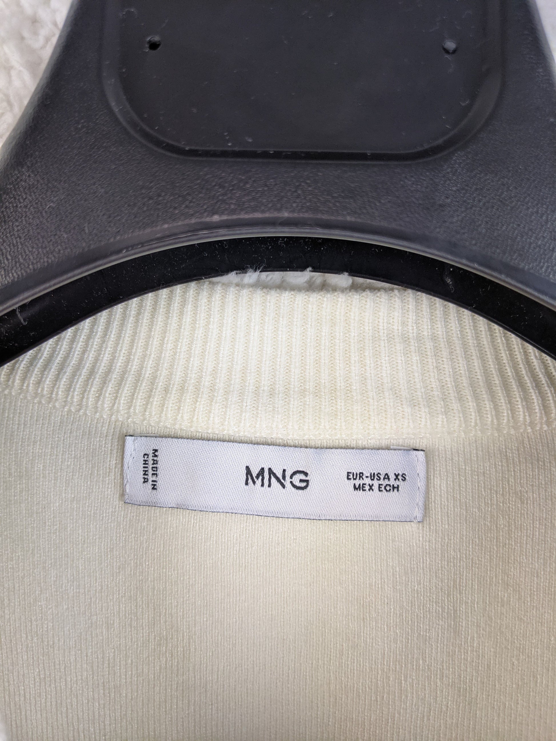 Close-up of MNG label on sweater