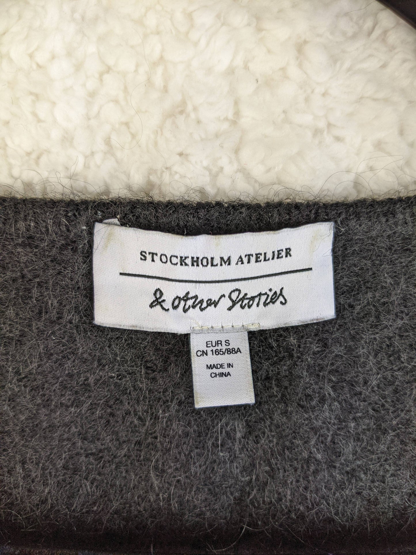 Close-up of & Other Stories label on sweater