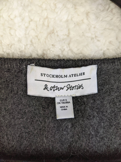 Close-up of & Other Stories label on sweater