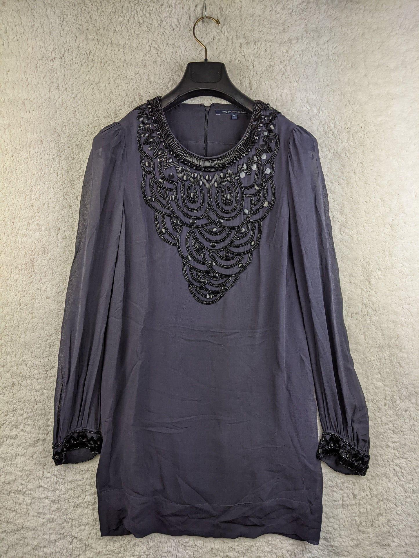 Front view of black beaded tunic dress