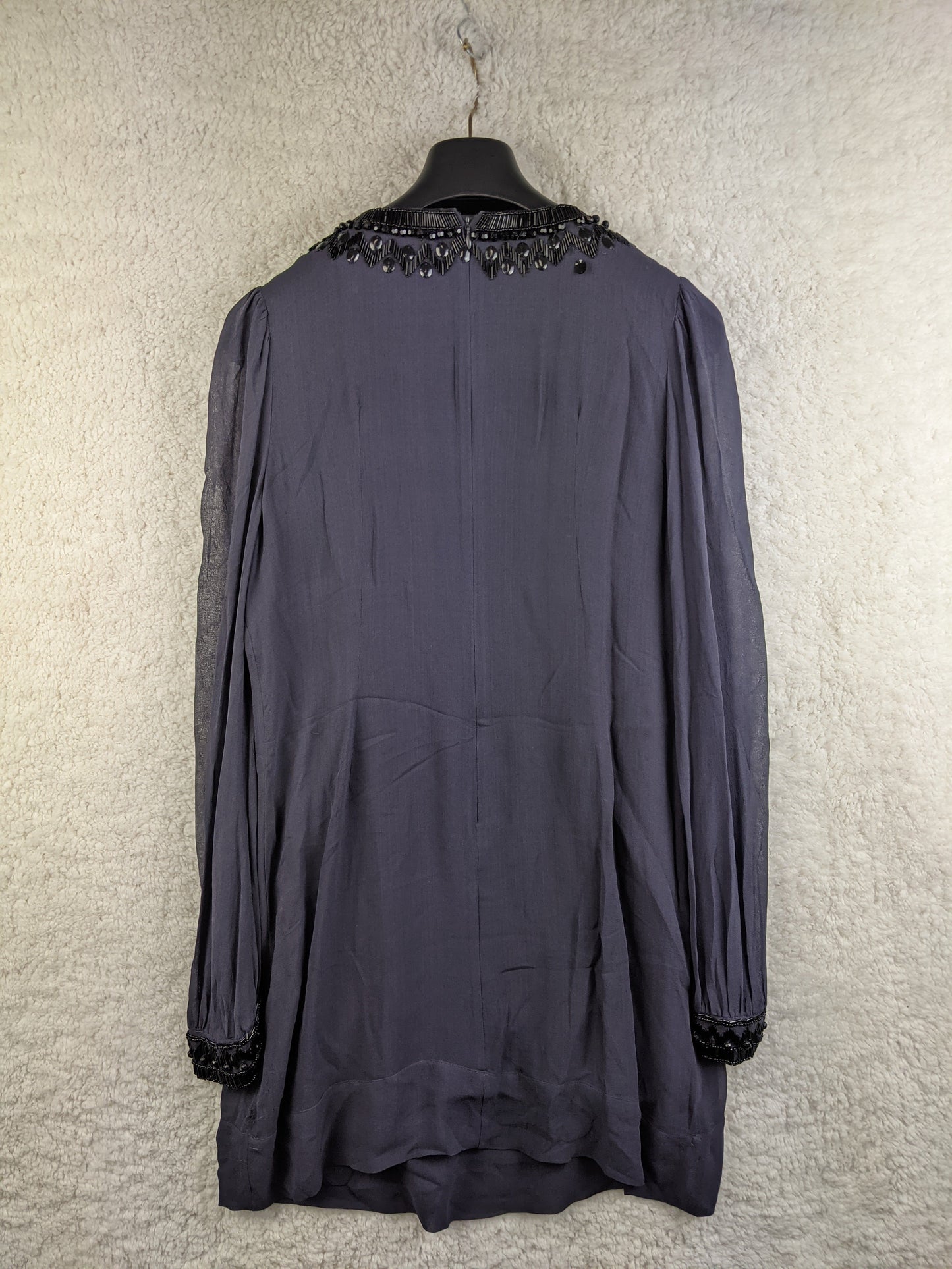 Back view of black beaded tunic dress