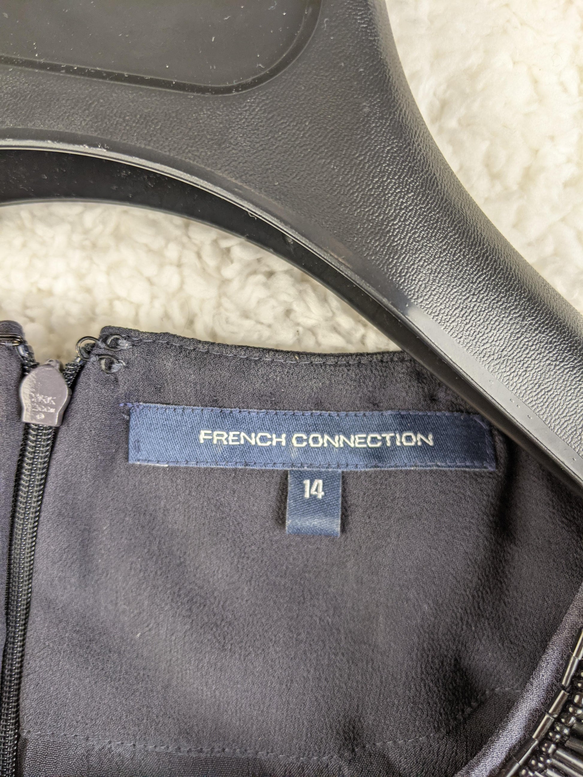 Close-up of French Connection label and size tag