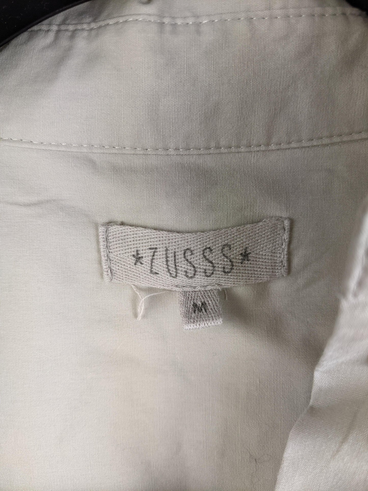 Zusss brand label on beige shirt dress