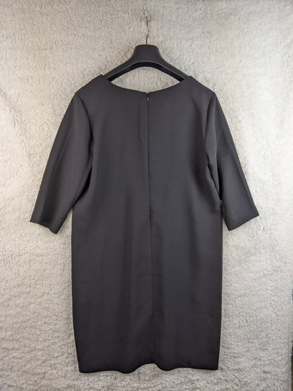 Back view of black dress on hanger