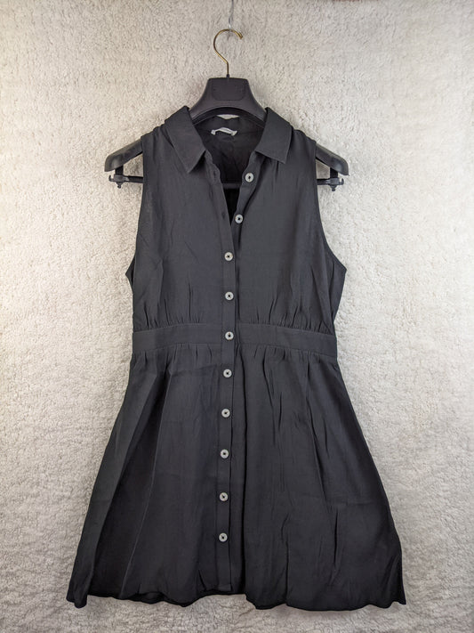 Front view of black sleeveless button-down dress by Cache Cache