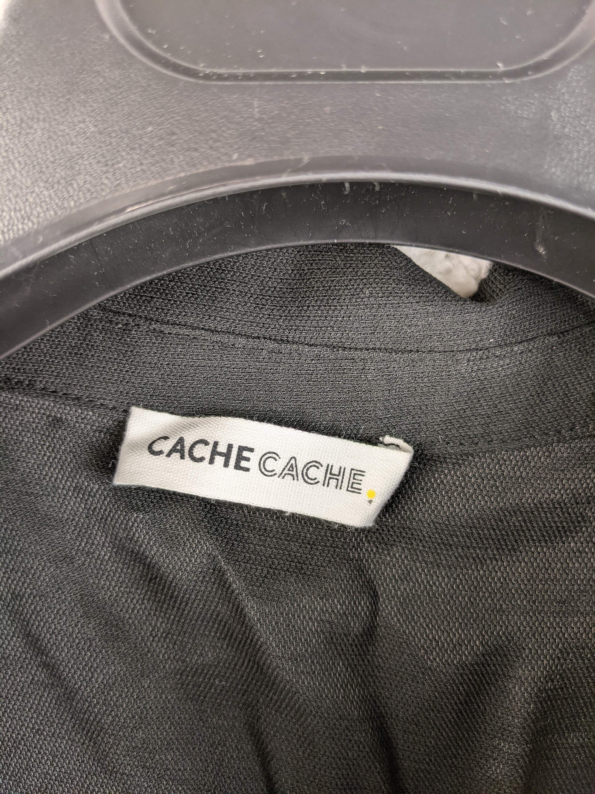 Brand label of Cache Cache on black dress