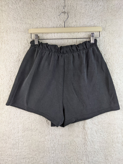 Back view of gray wrap-style shorts on hanger