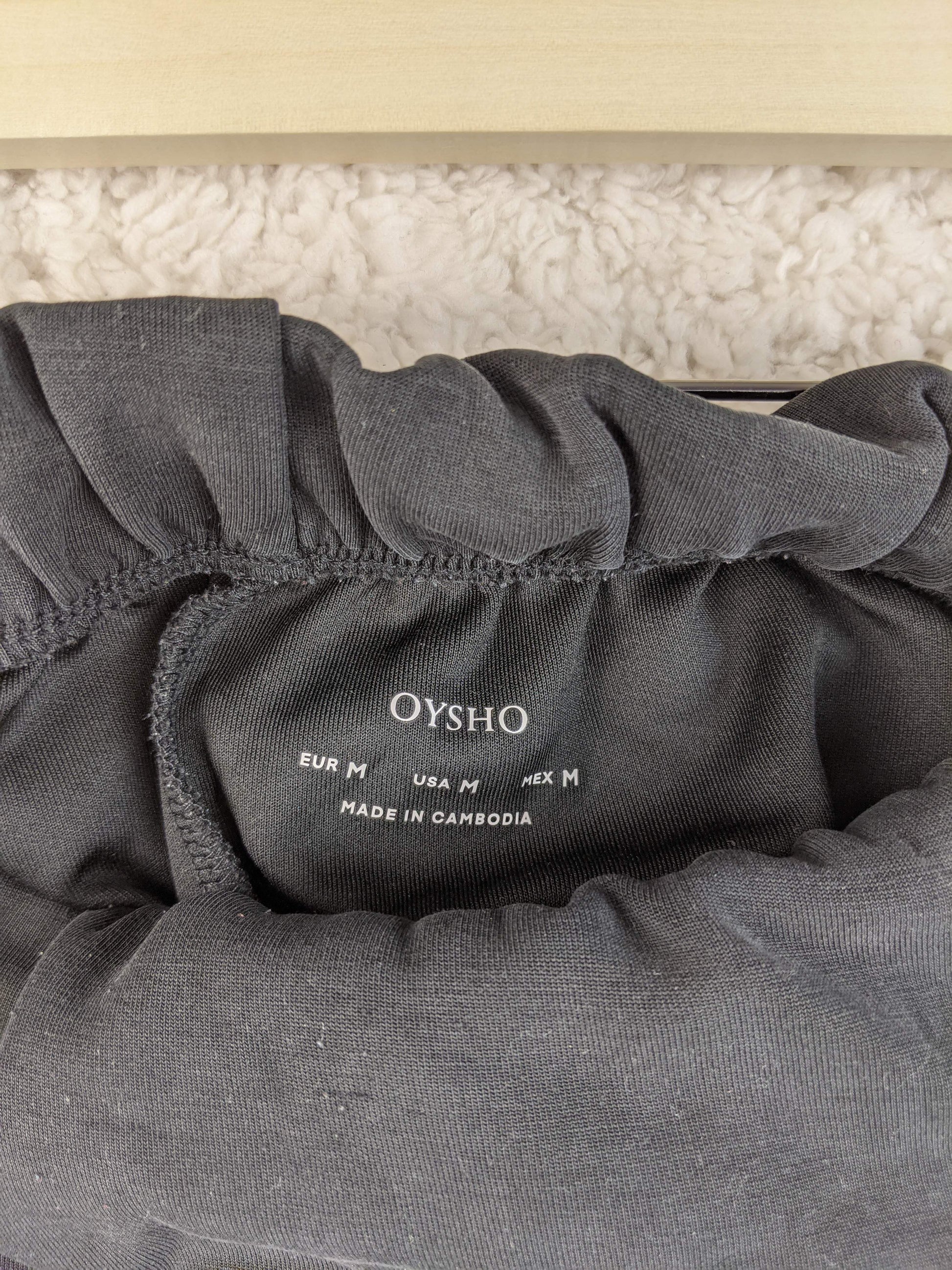 Close-up of Oysho label on gray shorts