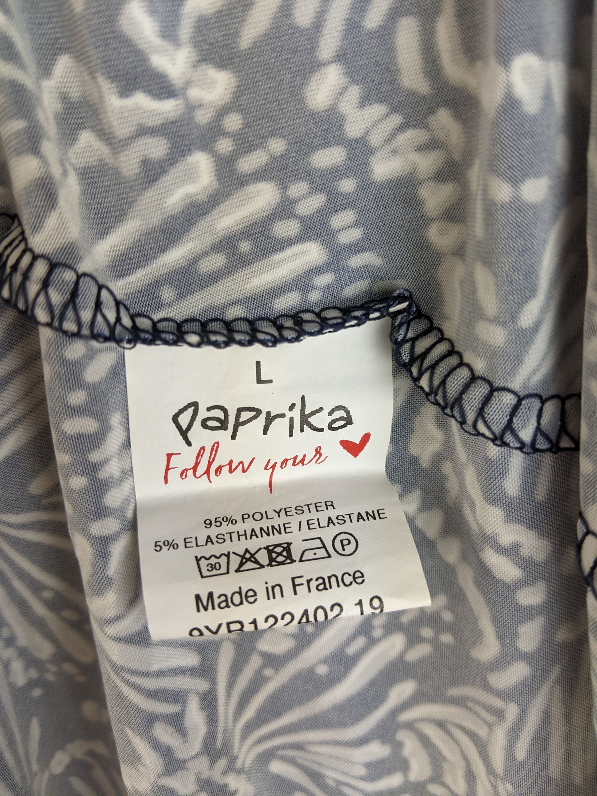Size and material label of navy and white floral dress