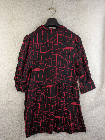 Back view of black and red printed Desigual dress on a hanger