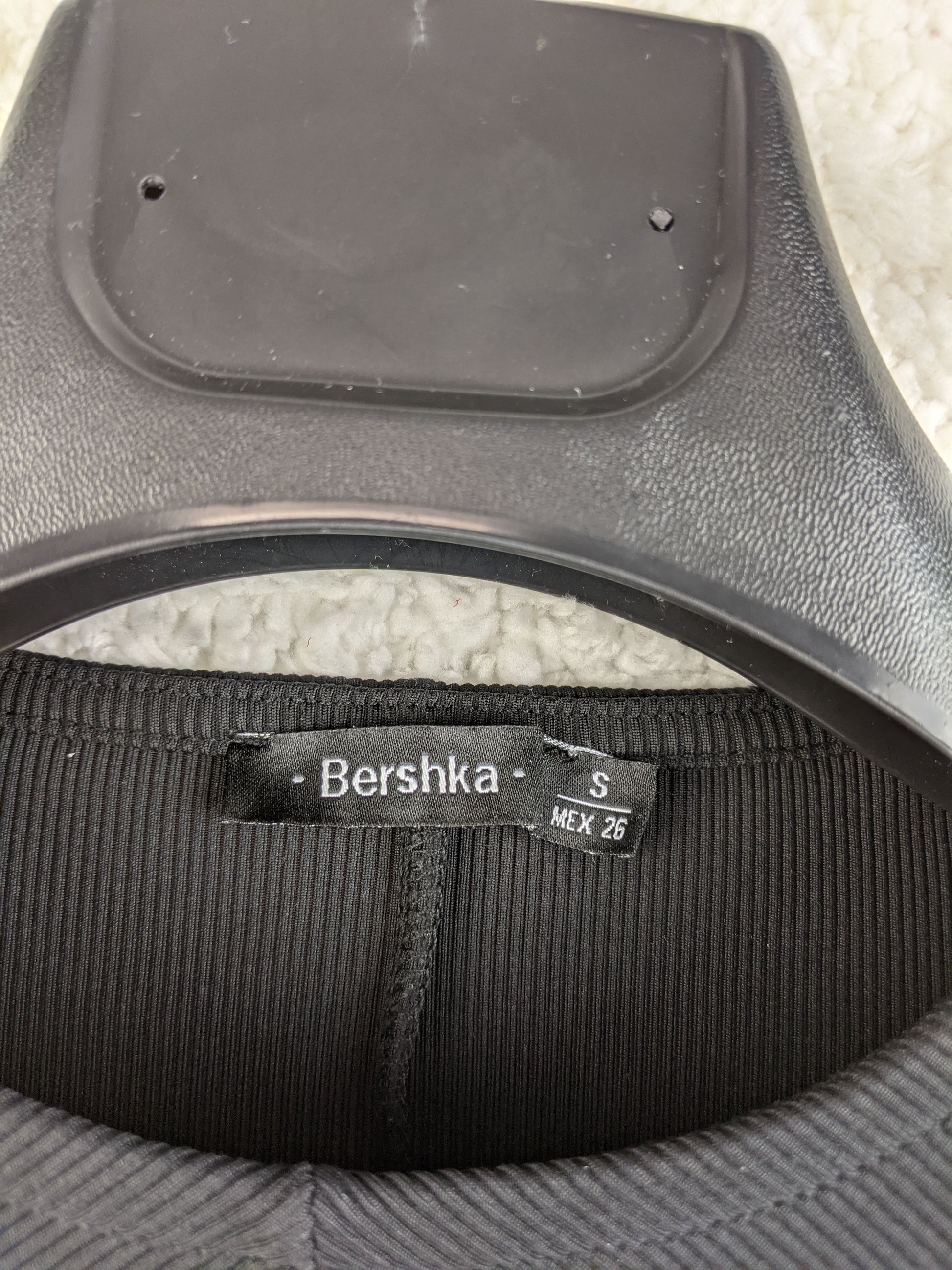 Close-up of Bershka label on dress