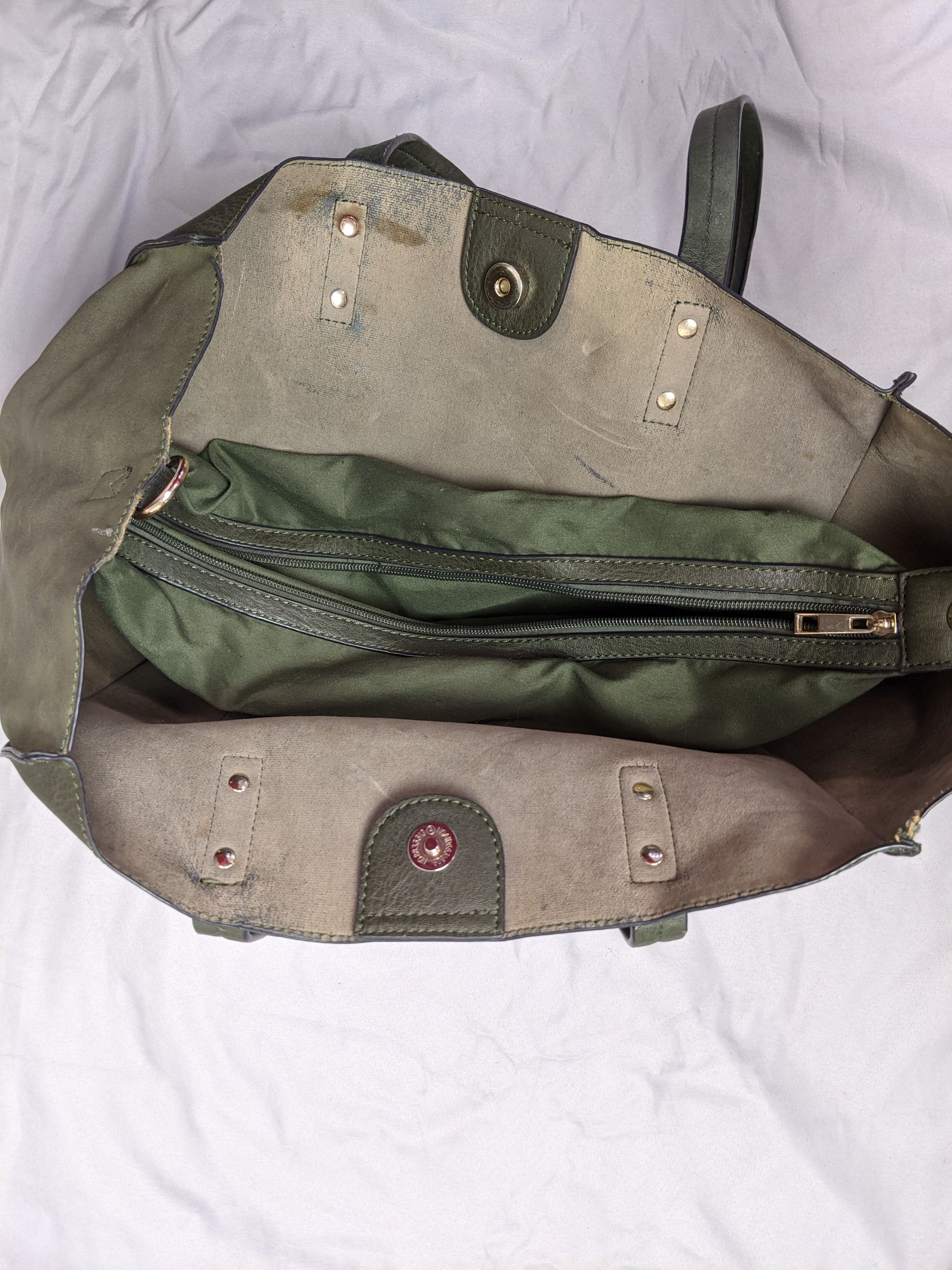 Interior of olive green tote bag showing zippered pocket