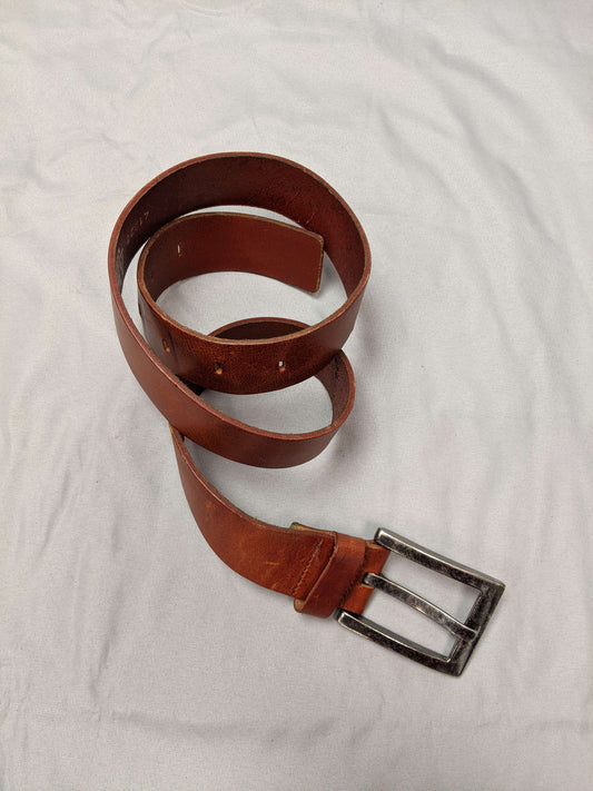 Brown leather belt with metal buckle