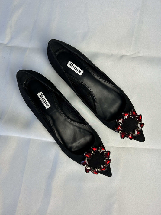 Top view of black ballet flats with embellishments