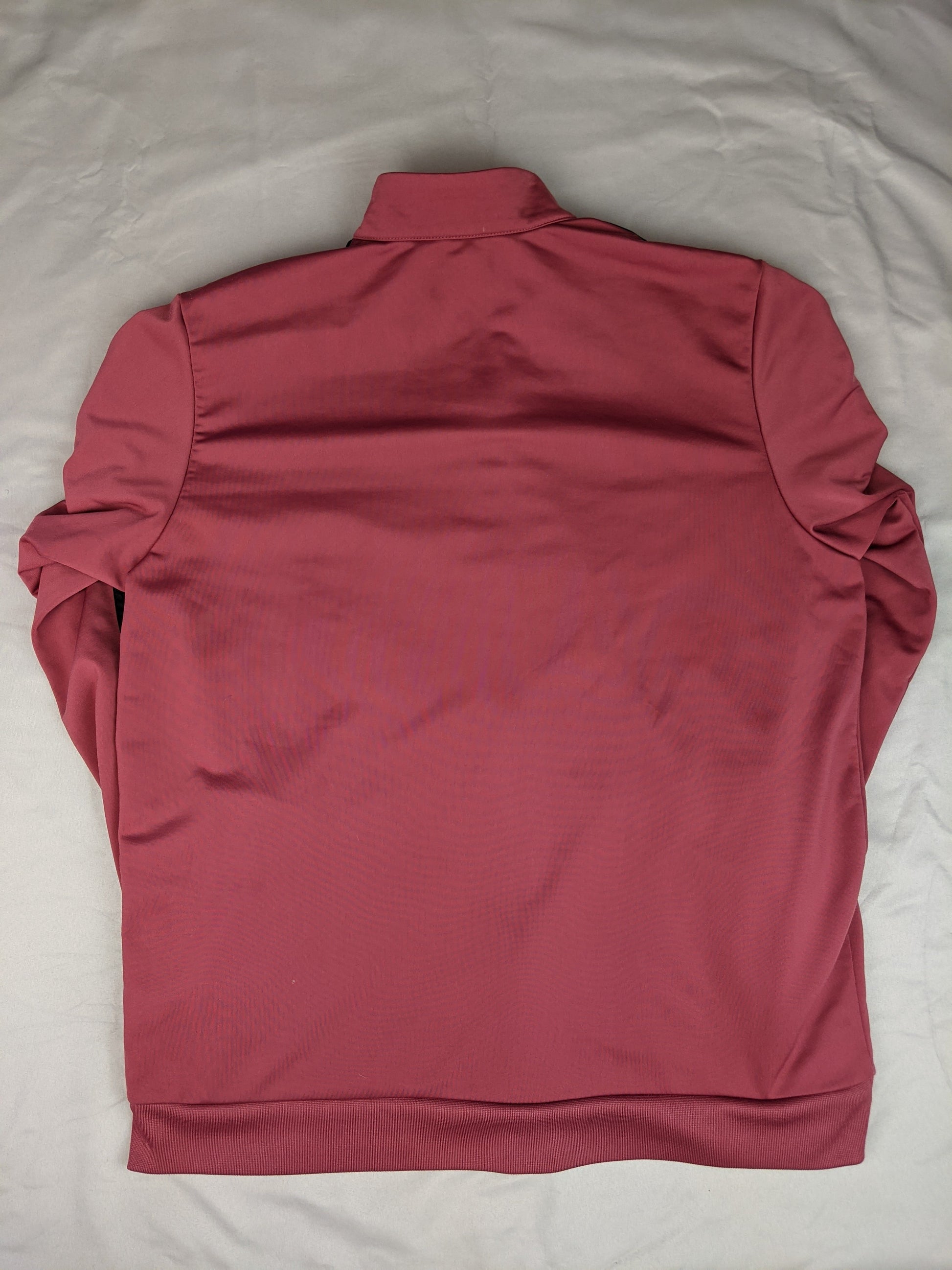Back view of maroon Adidas track jacket