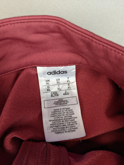 Size label of maroon Adidas track jacket