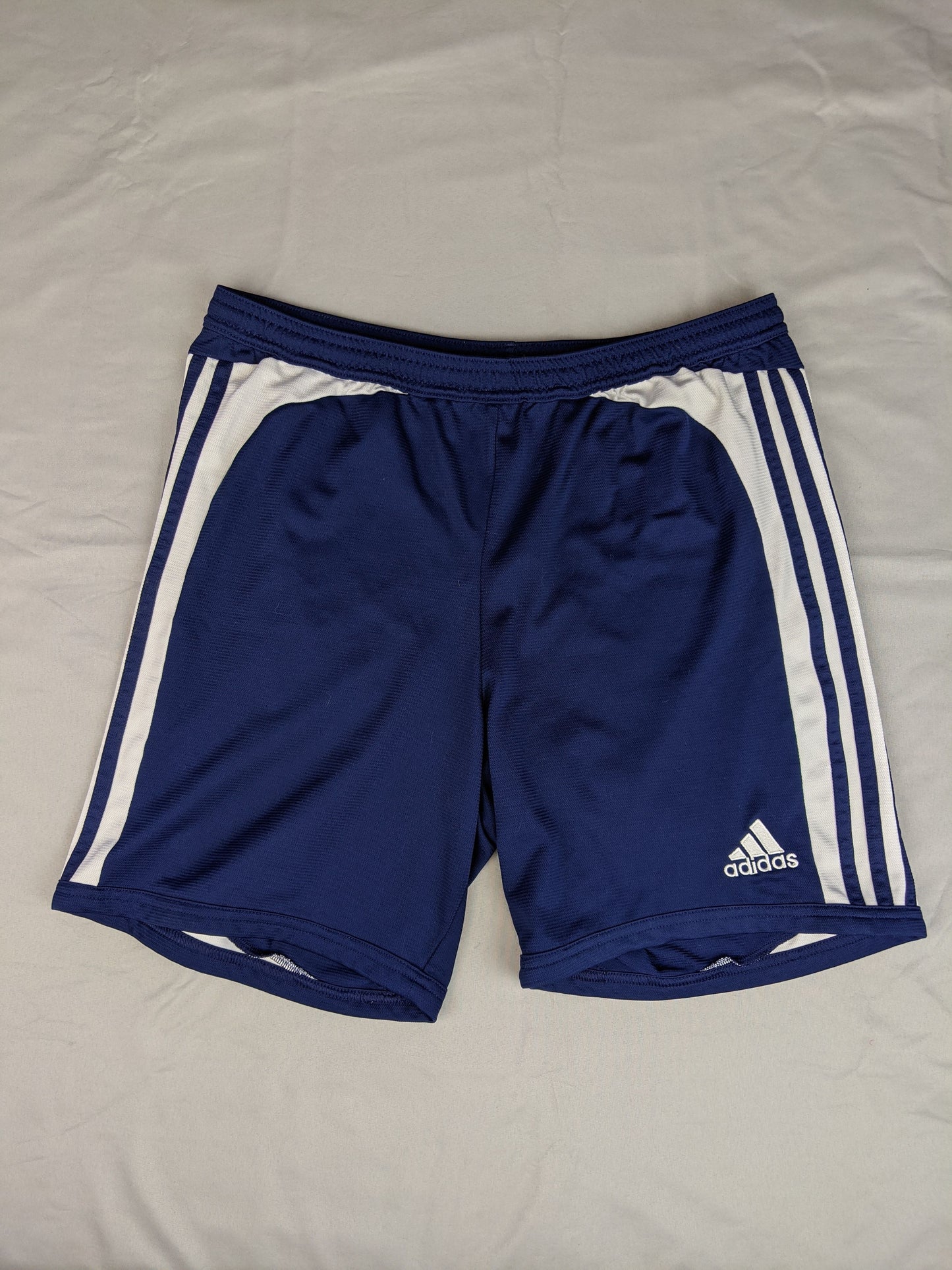 Front view of navy blue Adidas sports shorts